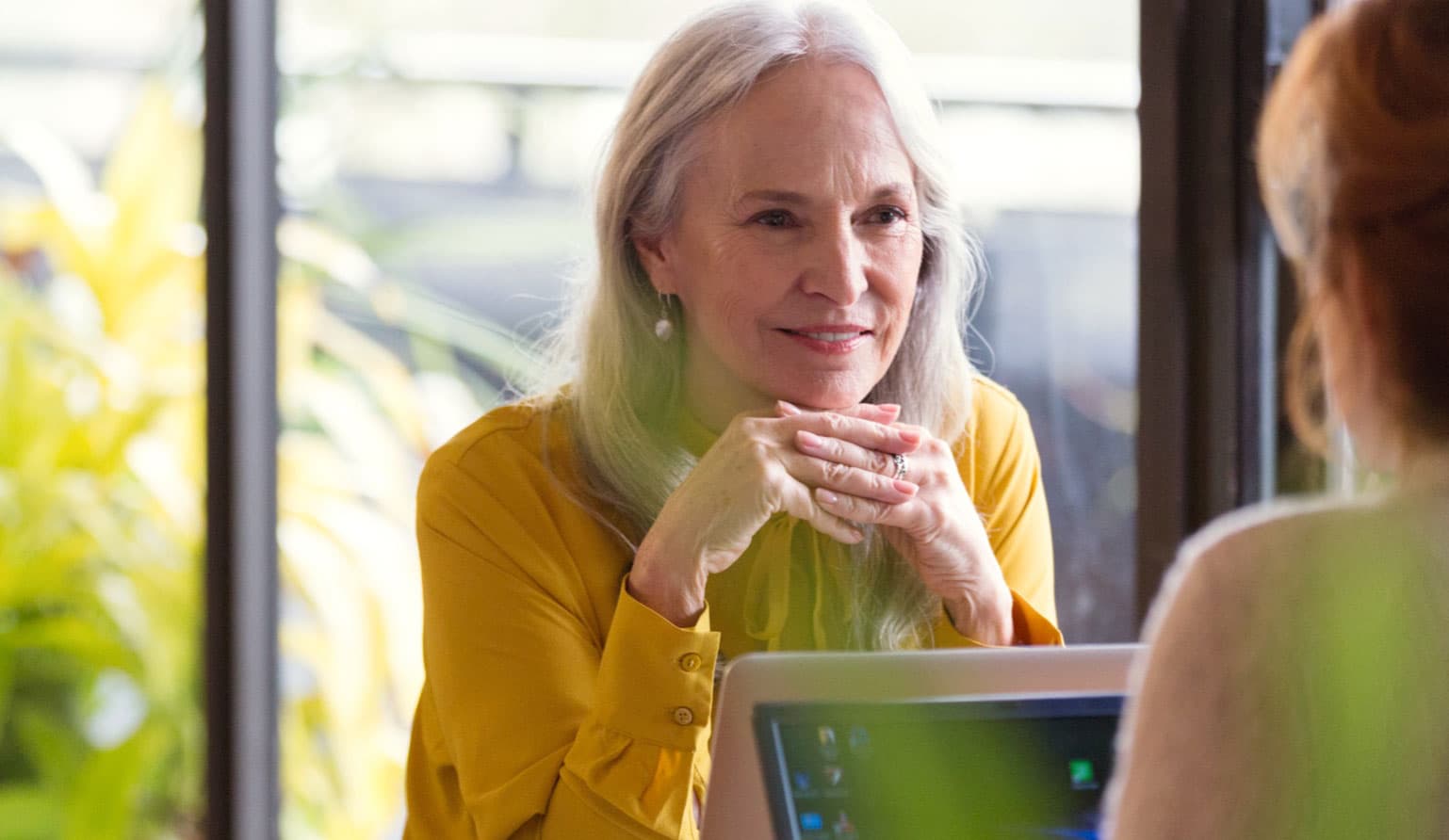 Woman talking with a friend depicting how support for Alpha-1 patients is important.